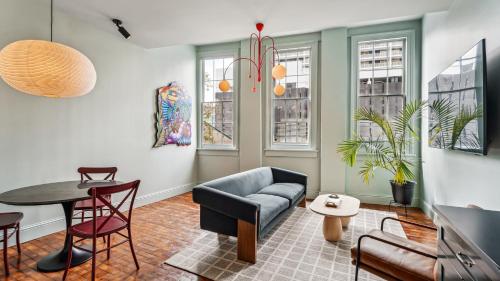 a living room with a couch and a table and chairs at The Mary Beth Hotel & Gallery in New Orleans