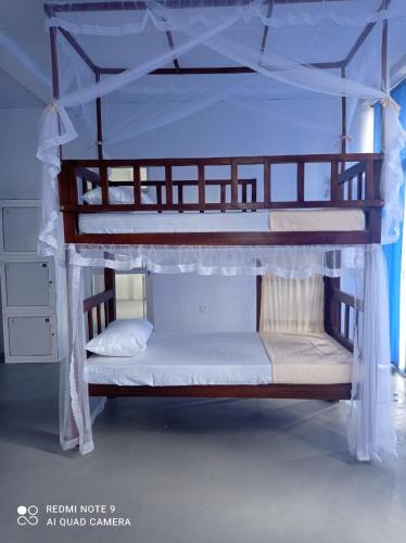 two bunk beds are shown in a room at Dream Sun hostel in Weligama