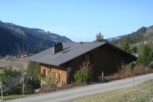 a brown house on the side of a road at Sonja in Schwarzsee