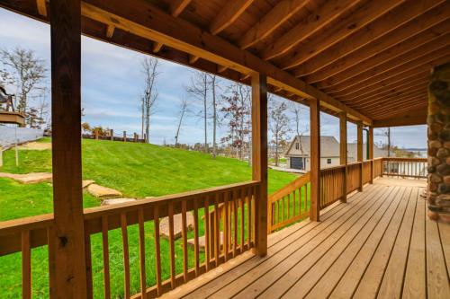 a large wooden deck with a view of a hill at Large Deck and Shared Dock Cabin on Kentucky Lake! in Gilbertsville