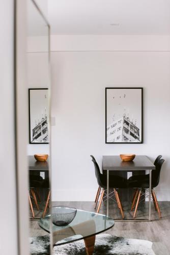 a dining room with a table and chairs at The VanderMarck Boutique Hotel in Collingwood