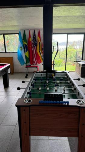 a room with a pool table and some flags at Espectacular casa Playa Hermosa, lagos y volcanes in Llanquihue