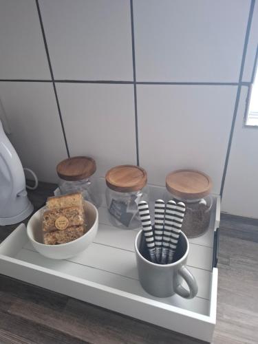 a shelf with a cup and a bowl of food at Seabreeze at the Beach in Strand