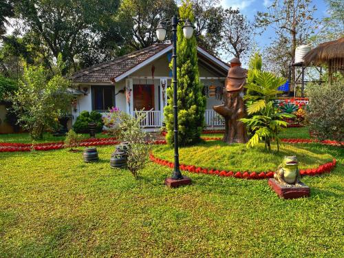 a house with a street light in the yard at Rimzim's Tatvamasi - You In Nature in Kudal