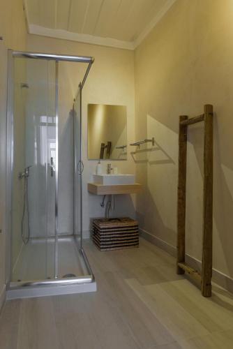 a bathroom with a glass shower and a sink at Lisbon Story Guesthouse in Lisbon