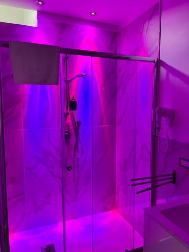 a bathroom with pink lights on a shower at Villa Delle Rose in Naples