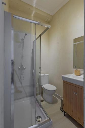 a bathroom with a shower and a toilet and a sink at Lisbon Story Guesthouse in Lisbon