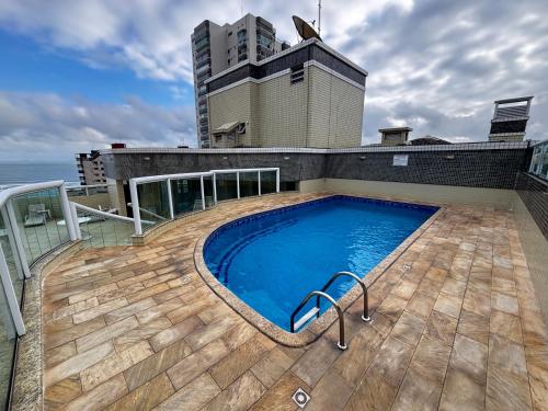 Πισίνα στο ή κοντά στο Apartamento inteiro com piscina à 100 metros do mar