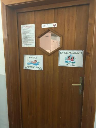 a door with signs on it with a box on it at Ploner villaggio Turistico in Dobbiaco