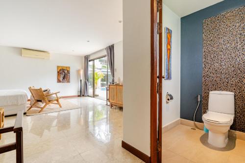 a bathroom with a toilet and a bedroom at Luxury 4BR Villa with Pool & Ocean Views on Patong in Patong Beach