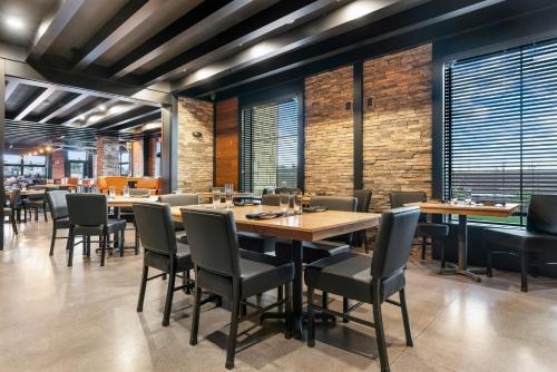 a dining room with wooden tables and chairs at Cobblestone Hotel & Suites - Lynden in Lynden