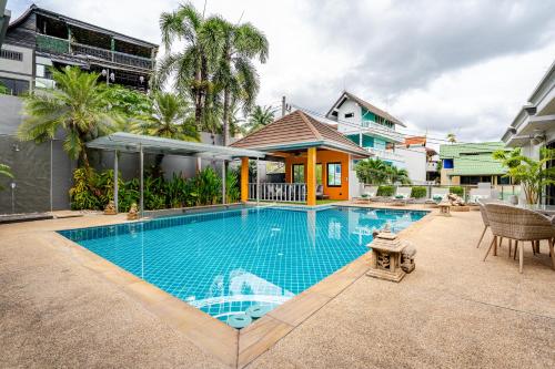 a swimming pool in front of a house at Luxury 4BR Villa with Pool & Ocean Views on Patong in Patong Beach