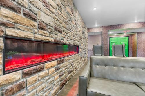 a stone wall in a bar with a fireplace at Cobblestone Hotel & Suites - Lynden in Lynden