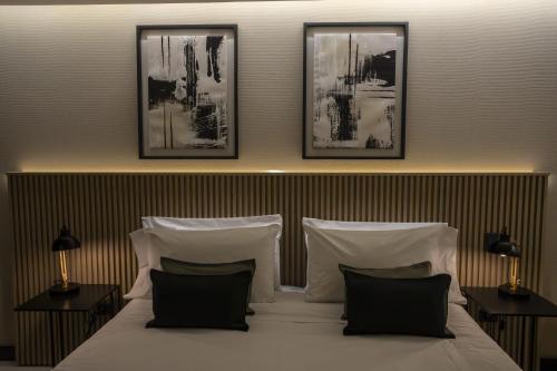 a bedroom with a bed with four pictures on the wall at Mabra Suites in El Calafate