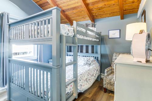 a blue bunk bed in a room with a bunk bed at Walk to Beach Water-View Seabrook Sanctuary in Seabrook