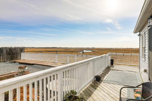 a balcony of a house with a white railing at Walk to Beach Water-View Seabrook Sanctuary in Seabrook