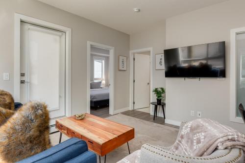 a living room with a blue couch and a table at Inner City Apartment, Pet Friendly, Free Underground Parking in Calgary