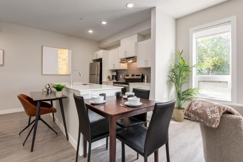 a kitchen and dining room with a table and chairs at Inner City Apartment, Pet Friendly, Free Underground Parking in Calgary
