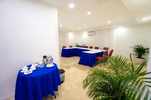 a meeting room with blue tables and chairs at Hotel 39 Jamaica in Montego Bay