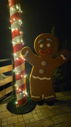 a gingerbread man statue next to a pole with lights at Willa Sulimówka - Noclegi Zakliczyn dom basen bania sauna SPA in Zakliczyn