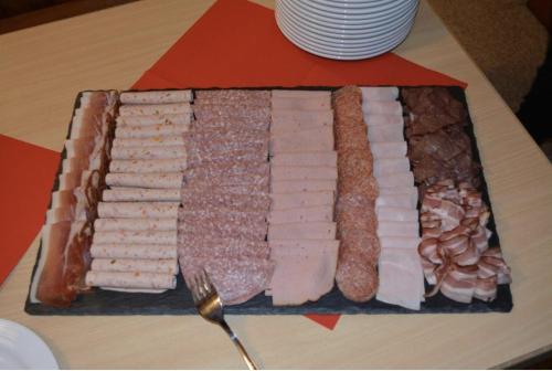 a tray of different types of meats on a table at Haus Engel Gams in Gams
