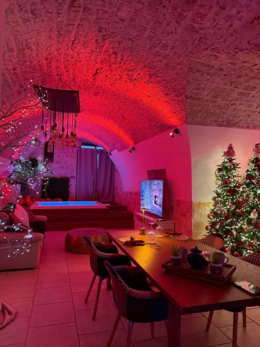 a living room with a christmas tree and red lights at Apulia Suite in Castellana Grotte