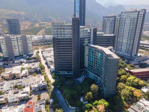 an aerial view of a city with tall buildings at Modern Apartments with Pool and Mountain views in Monterrey