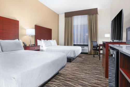 a hotel room with two beds and a television at Cobblestone Hotel & Suites - Lynden in Lynden