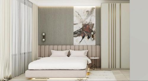 a bedroom with a bed and a painting on the wall at Karat Apartments with Parking Garage in Sarajevo