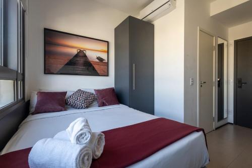 a bedroom with a large bed with towels on it at 360 VN Turiassú by Housi in Sao Paulo