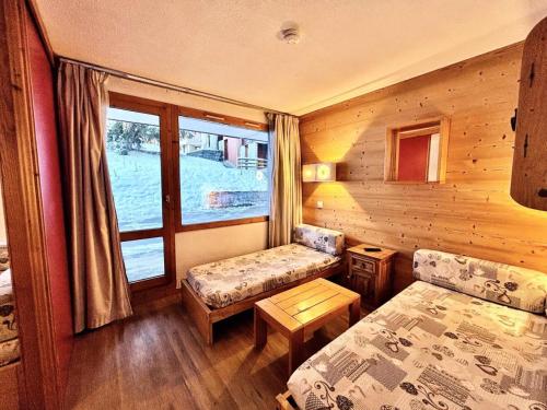 une chambre avec un lit, un canapé et une fenêtre dans l'établissement Résidence Le Zig Zag - ZIG ZAG 01 MAE-0391, à La Plagne Tarentaise