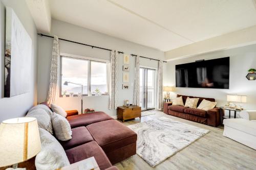 a living room with a couch and a large window at Pool Access and Mtn Views Cozy Sugar Mtn Escape in Sugar Mountain