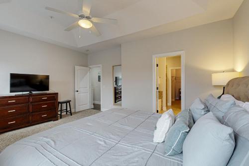 a bedroom with a large bed and a tv at Mariner's Landing 509 in Saint Simon Mills