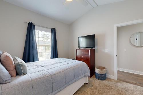 a bedroom with a bed and a flat screen tv at Mariner's Landing 509 in Saint Simon Mills