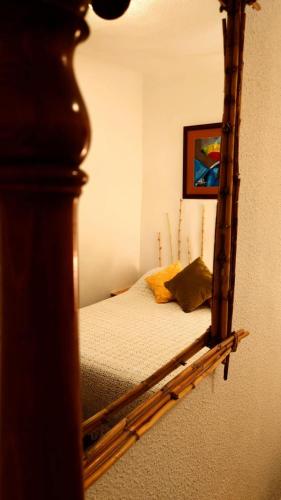 a mirror reflection of a bed in a bedroom at Entre el mar y la montaña in Jijona