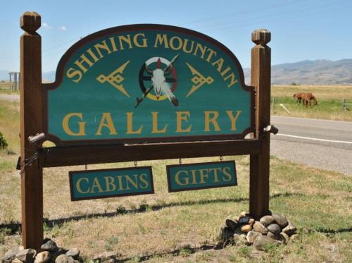 a sign for the swinging mountain valley calving cities at Chico Peak cabin nr Yellowstone,Chico Hot Springs in Pray