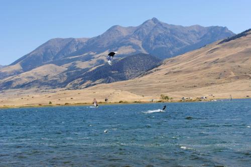 a bird flying over a body of water at Chico Peak cabin nr Yellowstone,Chico Hot Springs in Pray