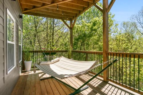 a hammock on the porch of a house at LUXE, Breathtaking Mountain Views, Hot Tub, Fire Pit, Fire Pit Table, Pool Table, 2 Living rooms, Universal EV Station in Hendersonville