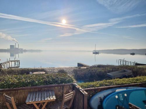 a view of the water with a bench and a hot tub at Exclusive Location At The Water's Edge in Kolding