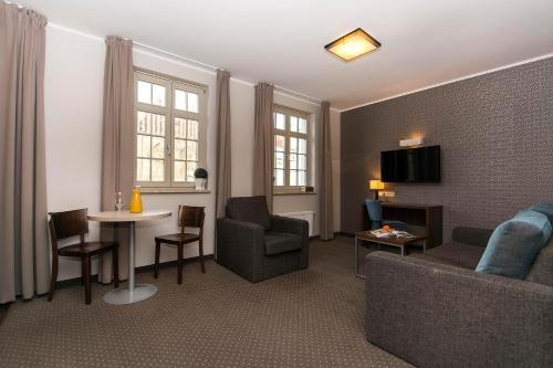 a living room with a couch and a table at Apart Neptun in Gdańsk