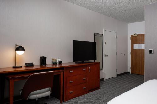 a hotel room with a desk with a television on it at Courtyard Denver Tech Center in Greenwood Village