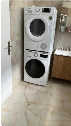 a microwave sitting on top of a stove in a kitchen at Home4U apt1, just 8Km from airport in Markopoulo