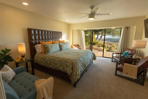 a bedroom with a bed and a couch and a window at Kiler Ranch House in Paso Robles