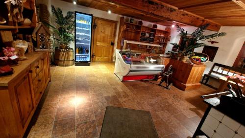 a large room with a kitchen with a refrigerator at Sonnleit'n Zimmer 3 in Abtenau