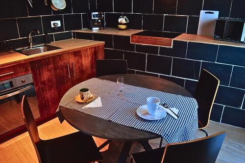 a kitchen with a table with a plate of food at Cabaña con Piscina en Doniños in Doniños