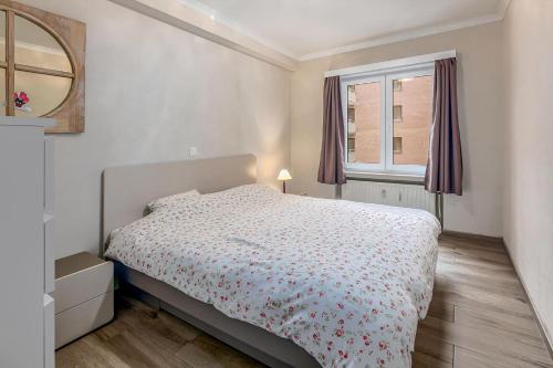 a bedroom with a bed and a window at Sun Beach 0201 in Sint-Idesbald