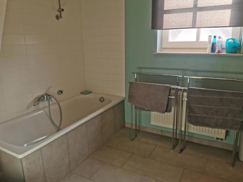 a bathroom with a bath tub and a sink at Vlierhof in Sint-Idesbald