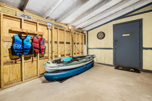 a room with a boat in a room with a door at Creekside Cabin - Beaver Lake Creek Access in Rogers
