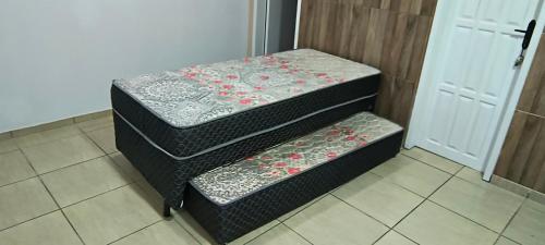 En eller flere senge i et værelse på Pousadinha Guaratuba