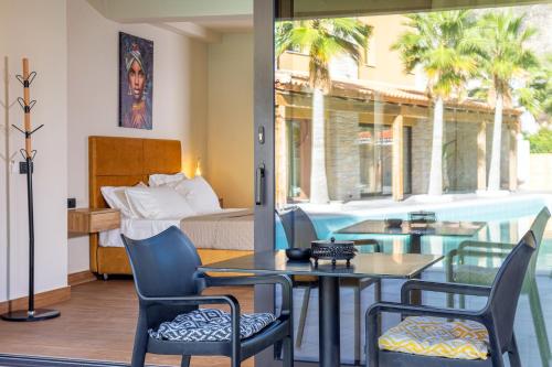 a hotel room with a bed and a table and chairs at Doce Dioses , By IdealStay Experience in Lygaria